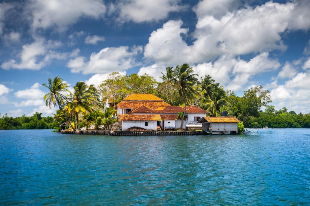 Buildings on peninsula, tropical plants. Sri Lanka