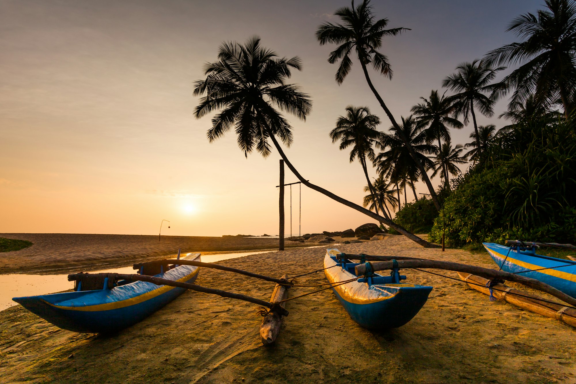 Fishing boat on the beach at sunset. Sri Lanka