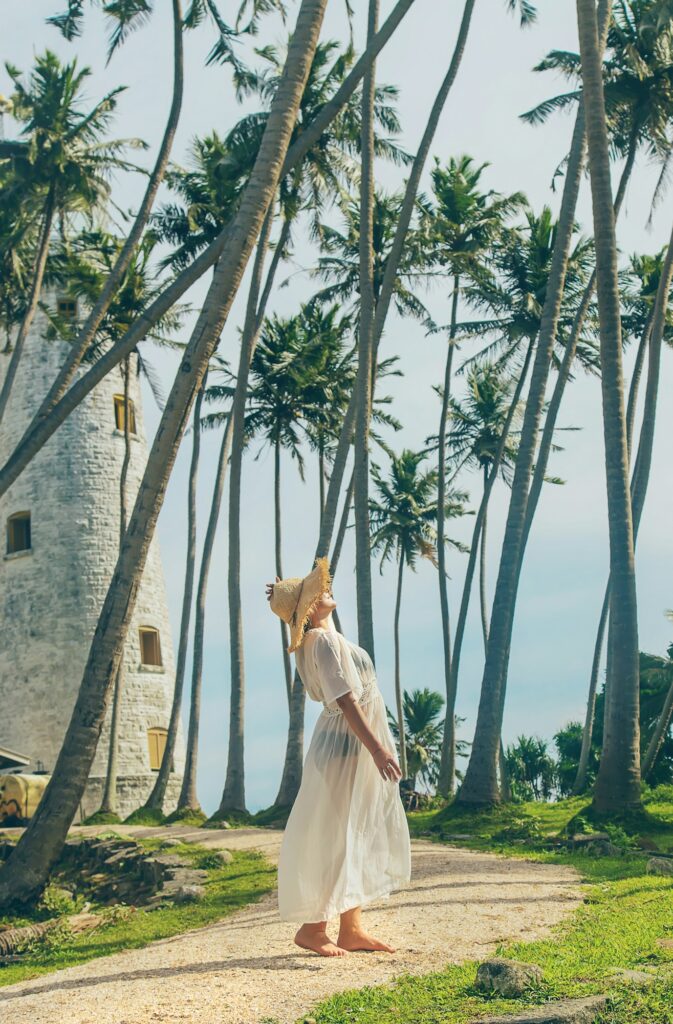 Girl in Sri Lanka on an island with a lighthouse. Selective focus.